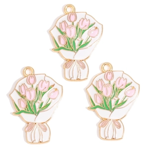 Detailed macro of three gold-plated tulip bouquet charms with pink and white enamel finish
