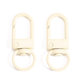 Macro view of beige metal swivel lobster clasps with smooth paint finish for DIY accessories