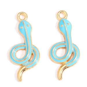 Close-up of golden snake charms with vibrant sky blue enamel inlay for DIY jewelry
