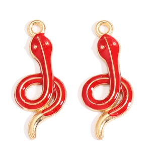 Detail of red enamel snake charms in gold finish for DIY jewelry and necklaces