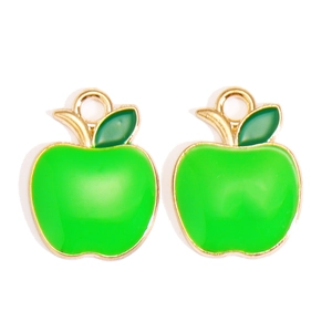 Close-up of green apple enamel alloy pendants with golden edges for jewelry making