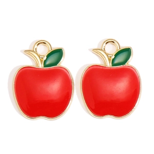 Detailed view of red enamel apple charms with gold borders for DIY jewelry making