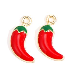 Macro shot of red chili enamel alloy charms with gold plating for jewelry DIY