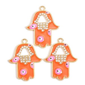 Hamsa Hand hangers met boze oog in oranje emaille en goudkleurige strass details