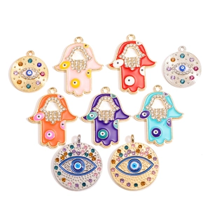 Hamsa Hand en Evil Eye hangers in diverse kleuren met strass en goud/zilver plating