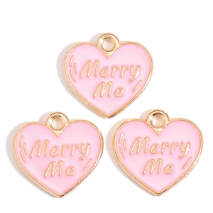 Three pink enamel heart charms with gold Merry Me text for DIY jewelry making