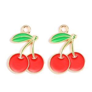 Detail van rode kersenbedels met groene bladeren en gouden haken voor DIY-sieraden