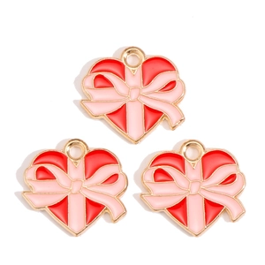 Three red enamel heart pendants with pink bows for DIY Valentine's Day jewelry making