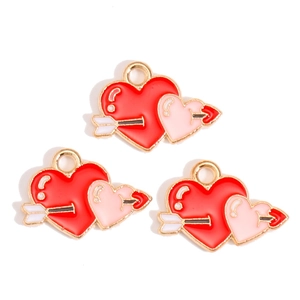 Detailed view of red and pink heart charms with golden arrow for DIY jewelry making