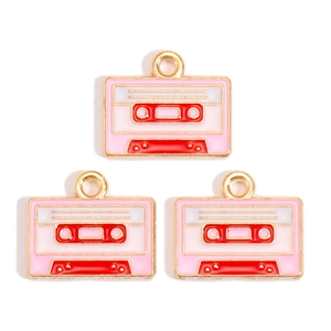 Detailed view of pink and white vintage cassette tape charms for DIY jewelry making