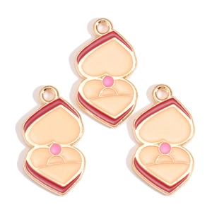Detail of three enamel heart ring box charms with gold plating for DIY jewelry making