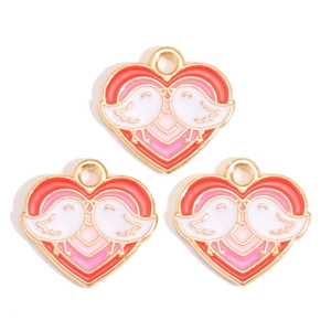 Detailed view of heart-shaped enamel charms with bird design for DIY jewelry making