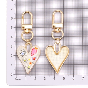 Colorful evil eye heart keychain with gold metal frame shown from front and back view