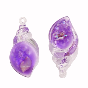 Close-up of translucent purple resin conch pendants with glitter for DIY jewelry making