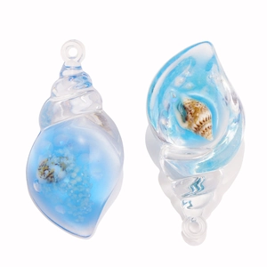 Close-up of sky blue luminous acrylic seashell pendants with embedded natural shells