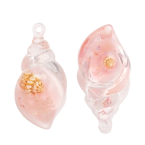 Detailed macro of pink gradient resin conch charms for DIY jewelry and accessories
