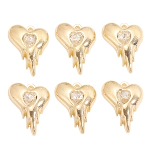 Vue détaillée de six pendentifs cœur en lave dorée avec cristaux dans une grille 2x3