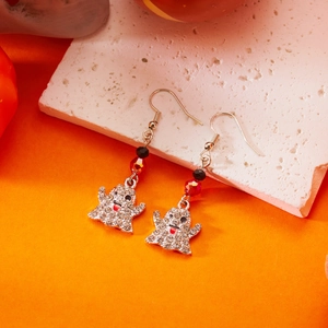 Dettaglio macro degli orecchini fantasma con strass scintillanti e perline rosse per Halloween
