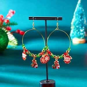 Detailsicht auf Weihnachts-Creolen mit Weihnachtsmann, Zuckerstange und bunten Perlen