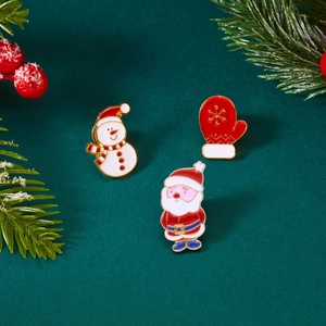 Detail der Weihnachts-Emaille-Pins mit Weihnachtsmann, Schneemann und roten Handschuhen