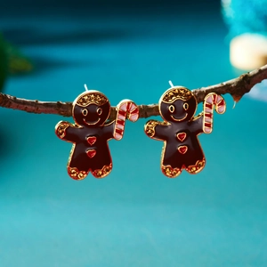 Gros plan de boucles d'oreilles bonhomme de pain d'épices avec bordure dorée et coeur