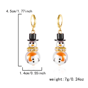 Detailed view of Christmas snowman earrings with white pearls and gold rhinestone rings