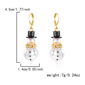 Detail of Christmas snowman earrings with black hat and rhinestone scarf on white background