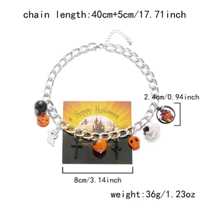 Detail of Halloween necklace with pumpkin, skull, and ghost pendants on silver chain
