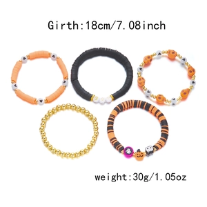 Close-up of Halloween stretch bracelet set with pumpkin charms and BOO letter beads