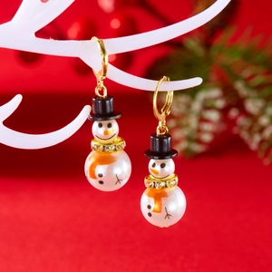 Detail shot of Christmas snowman earrings with white faux pearls and crystals on deer antlers