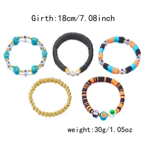 Detail view of 5-piece Halloween beaded bracelet set with BOO charms and pumpkin motifs