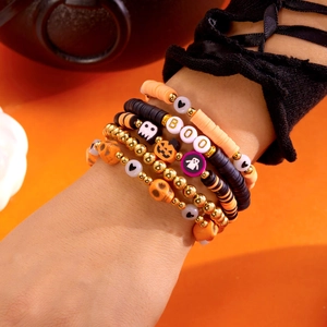 Close-up of Halloween beaded bracelet set with pumpkin, ghost, and skull charms