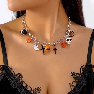 Macro shot of Halloween charm necklace featuring pumpkin, ghost, and bat pendants