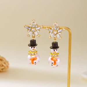 Detail shot of snowman earrings with pearl body, rhinestone scarf and black hat on stand