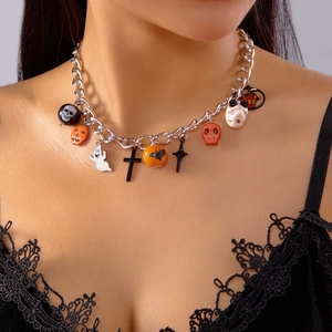 Detail of Halloween layered necklace with skull, pumpkin, ghost and bat charms on model