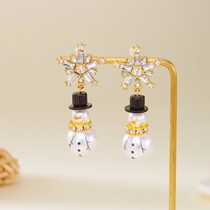 Detail of Christmas snowman earrings with sparkling rhinestones and pearl-like beads