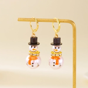 Detailed view of Christmas snowman pearl earrings with gold lever back and rhinestone scarf