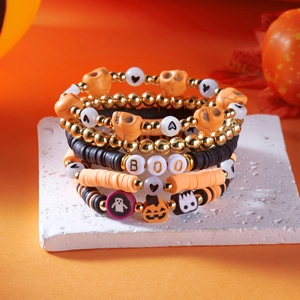 Detail of Halloween beaded bracelet set with BOO letters, skull and pumpkin charms