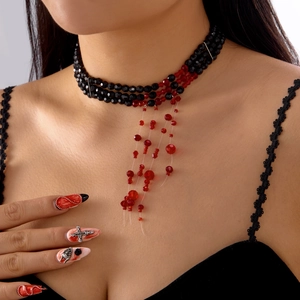 Gothic choker detail with black faceted beads and red blood drip fringe for Halloween