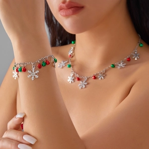 Detailed view of silver necklace and bracelet set with colorful bells and snowflake charms