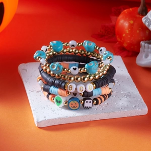 Detailed view of Halloween beaded bracelets with BOO letters and pumpkin charms
