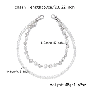 Detailed view of layered pearl trouser chain with diamond flower charms and silver clasps