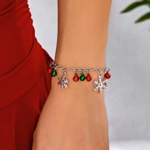 Detailed view of a Christmas bracelet with colorful bells and rhinestone snowflakes