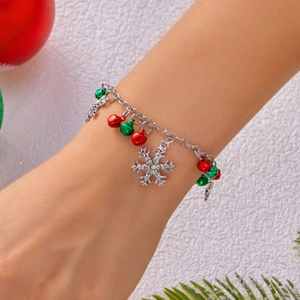 Detailed view of Christmas bracelet with silver snowflake pendant and colorful bell charms
