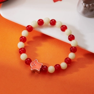 Detailed view of beaded Halloween bracelet with pink ghost charm on ceramic stand