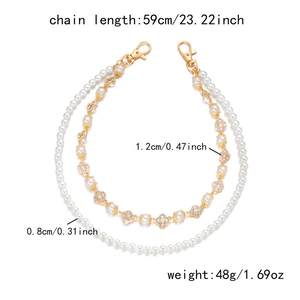Detail showing double-layered pearl and clover cross chain with 59cm length specifications
