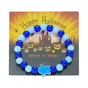 Close-up of blue beaded Halloween bracelet with ghost charm on festive card
