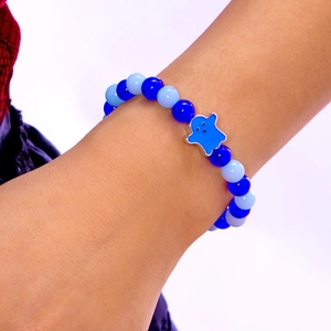 Luminous beaded bracelet featuring a blue ghost charm and festive pumpkin accents
