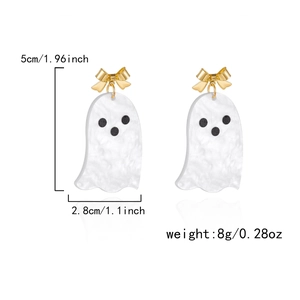 Detailed view of Halloween ghost drop earrings with golden bows and acetate texture