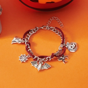 Detalle de pulsera de Halloween con dijes de araña, murciélago y calabaza tallada